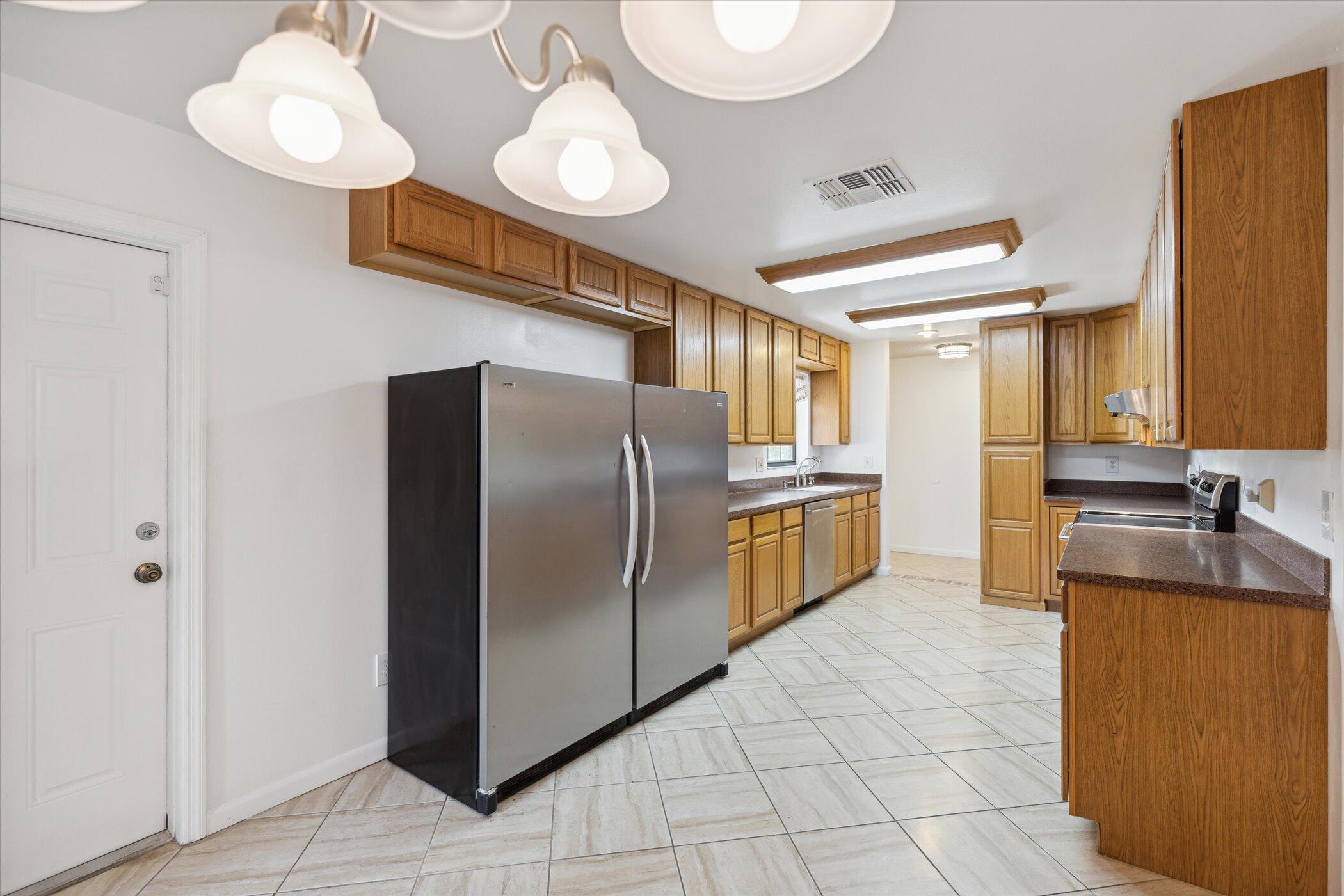 1045 Garden Road Merritt Island, FL 32952 - Photo 10 of 37 a kitchen with cabinets and stainless steel appliances