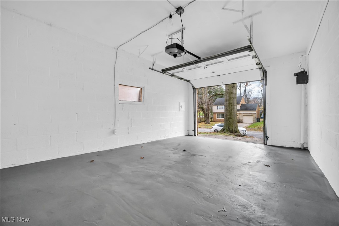 1605 Laclede Road Cleveland, OH 44121 - Photo 29 of 40 Garage featuring concrete block wall and a garage door opener