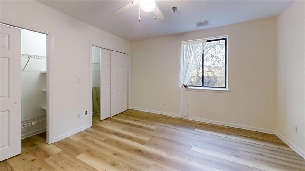 300 Johnson Ferry Road, Unit A312 Atlanta, GA 30328 - Photo 11 of 31 a view of an empty room with wooden floor and a window