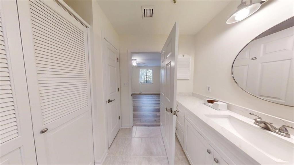 300 Johnson Ferry Road, Unit A312 Atlanta, GA 30328 - Photo 12 of 31 a bathroom with a sink a mirror and a shower