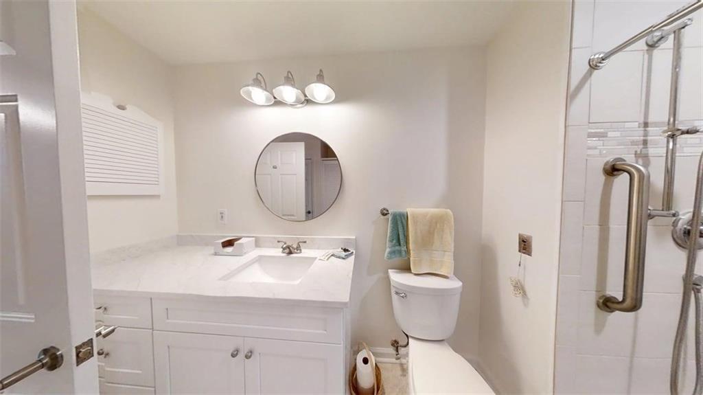 300 Johnson Ferry Road, Unit A312 Atlanta, GA 30328 - Photo 14 of 31 a bathroom with a toilet sink and mirror