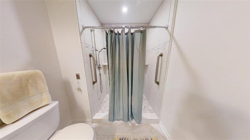300 Johnson Ferry Road, Unit A312 Atlanta, GA 30328 - Photo 15 of 31 a bathroom with a shower and a toilet