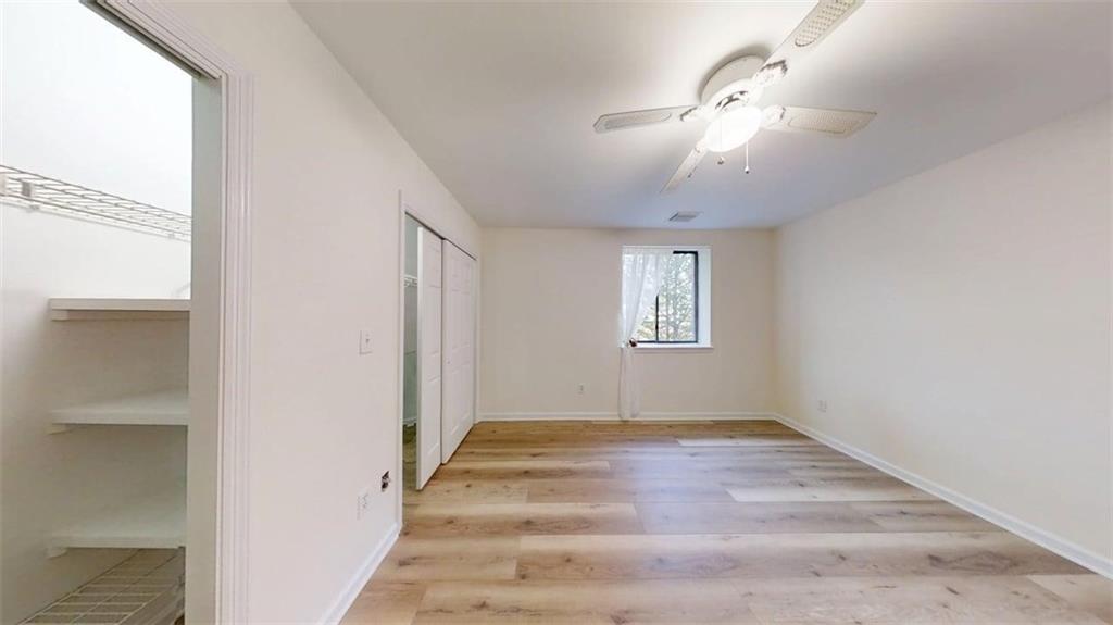 300 Johnson Ferry Road, Unit A312 Atlanta, GA 30328 - Photo 18 of 31 a view of an empty room with wooden floor and a window