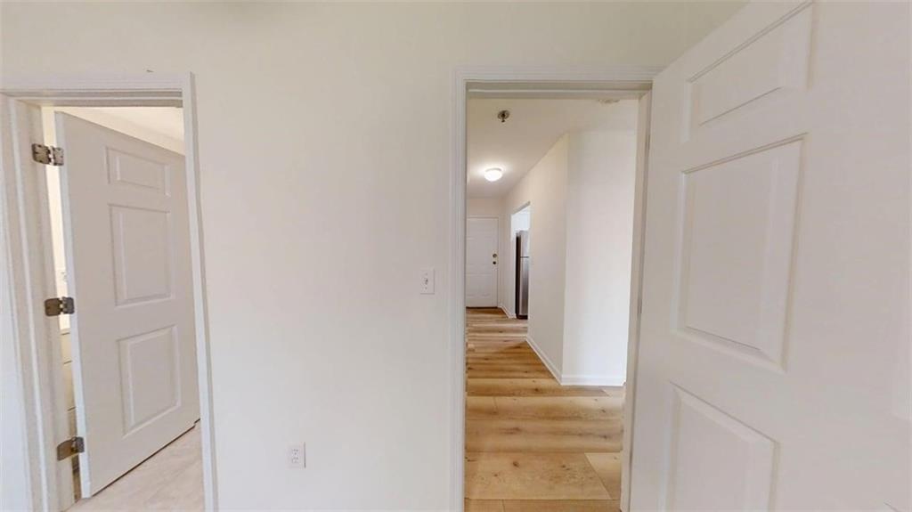 300 Johnson Ferry Road, Unit A312 Atlanta, GA 30328 - Photo 20 of 31 a view of a hallway with wooden floor and staircase