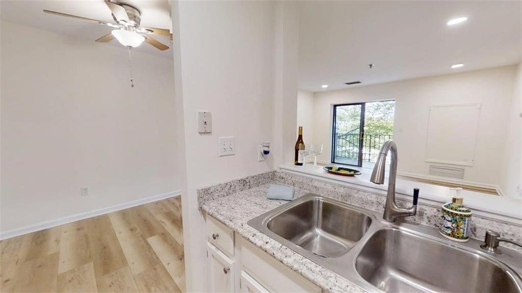 300 Johnson Ferry Road, Unit A312 Atlanta, GA 30328 - Photo 26 of 31 a kitchen with a sink cabinets and window
