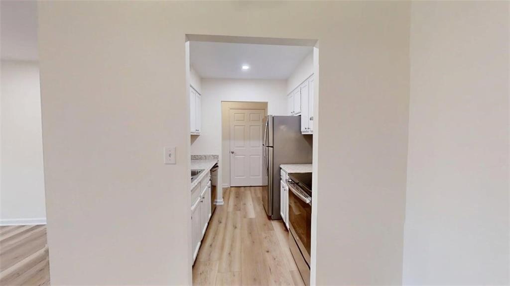 300 Johnson Ferry Road, Unit A312 Atlanta, GA 30328 - Photo 27 of 31 a view of a hallway with wooden floor and a bathroom