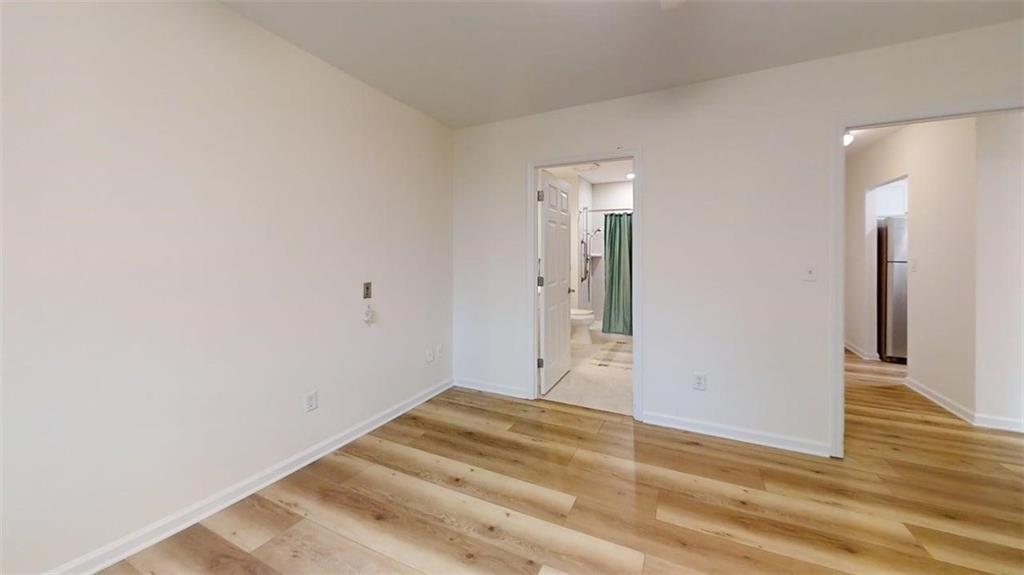 300 Johnson Ferry Road, Unit A312 Atlanta, GA 30328 - Photo 3 of 31 a view of a room with wooden floor and a bathroom