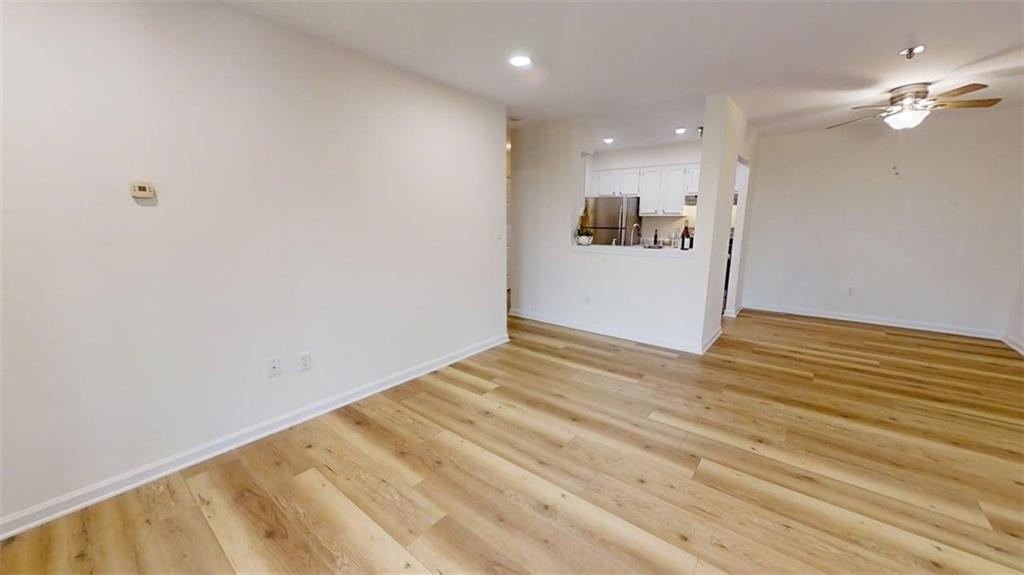 300 Johnson Ferry Road, Unit A312 Atlanta, GA 30328 - Photo 4 of 31 a view of a room with wooden floor and a ceiling fan