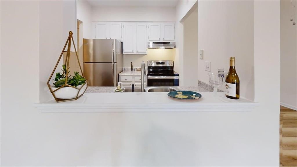 300 Johnson Ferry Road, Unit A312 Atlanta, GA 30328 - Photo 8 of 31 a view of a kitchen with refrigerator and windows