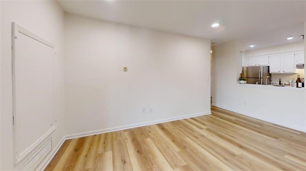 300 Johnson Ferry Road, Unit A312 Atlanta, GA 30328 - Photo 9 of 31 a view of a room with wooden floor and a window