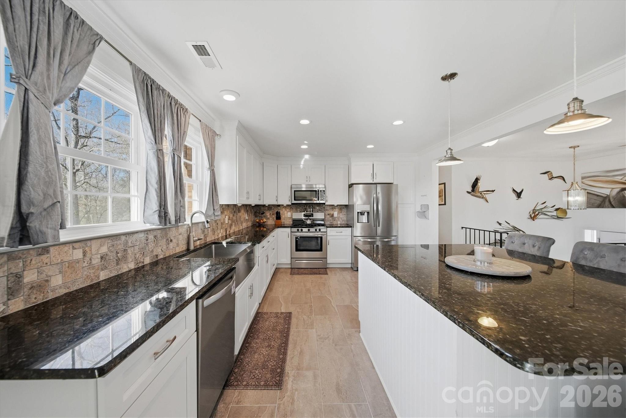 6719 Lakeview Terrace Hickory, NC 28601 - Photo 8 of 41 a large kitchen with granite countertop lots of counter space and window