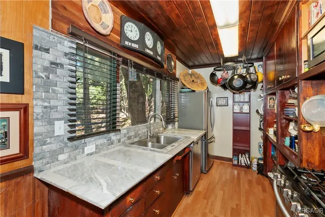 a kitchen with a sink a counter top space and furniture