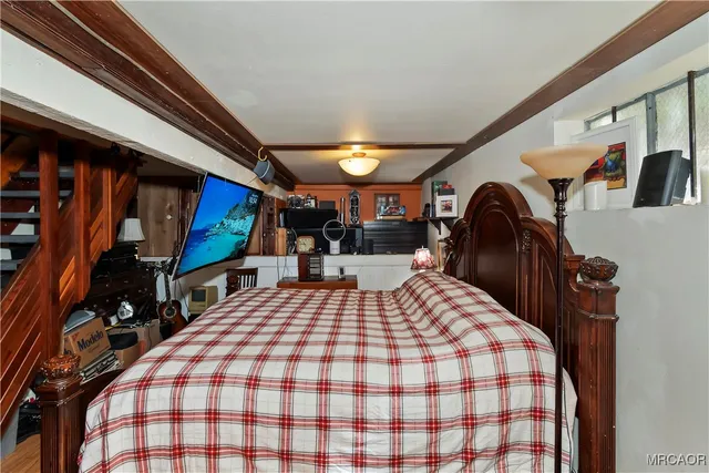 a bed room with a bed and a flat tv screen