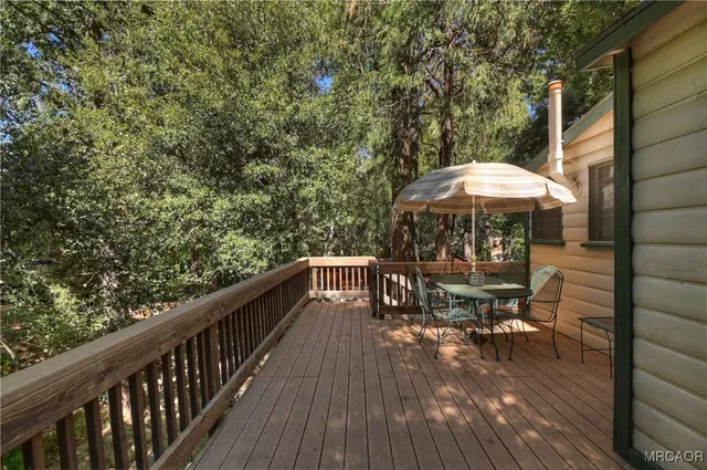 a view of a house with a yard and a tree