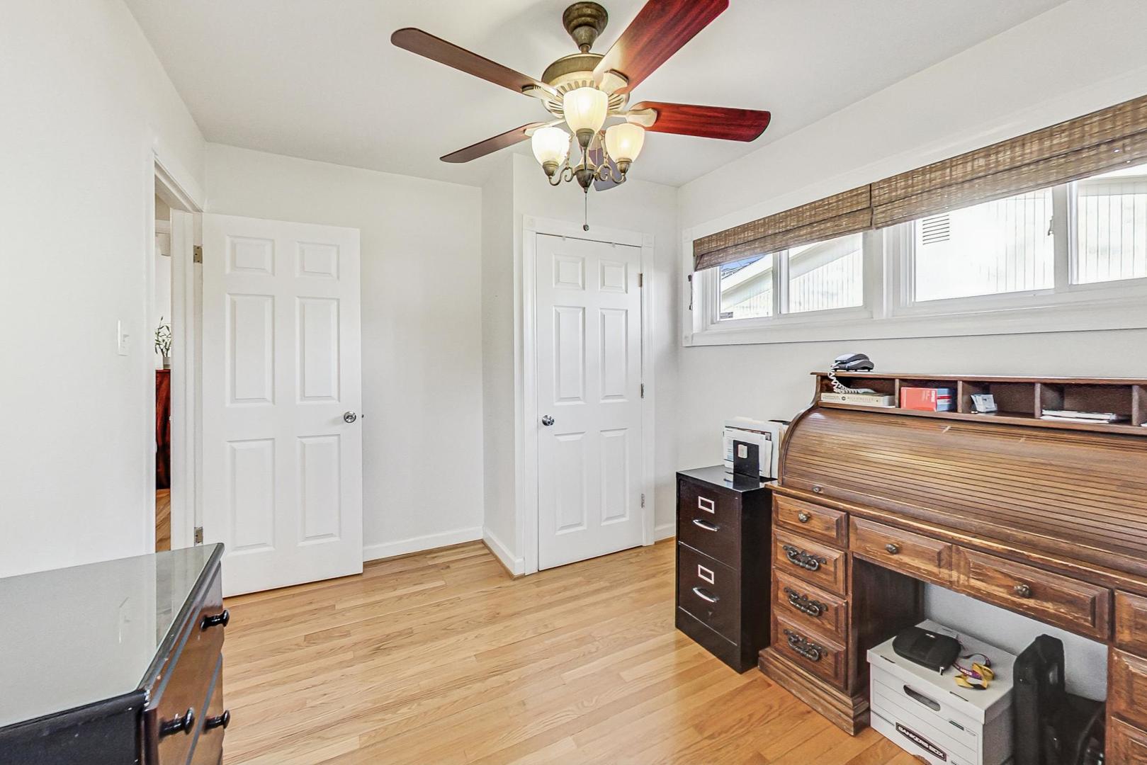 1016 Midway Road Northbrook, IL 60062 - Photo 12 of 27 a bed room with a bed and a ceiling fan
