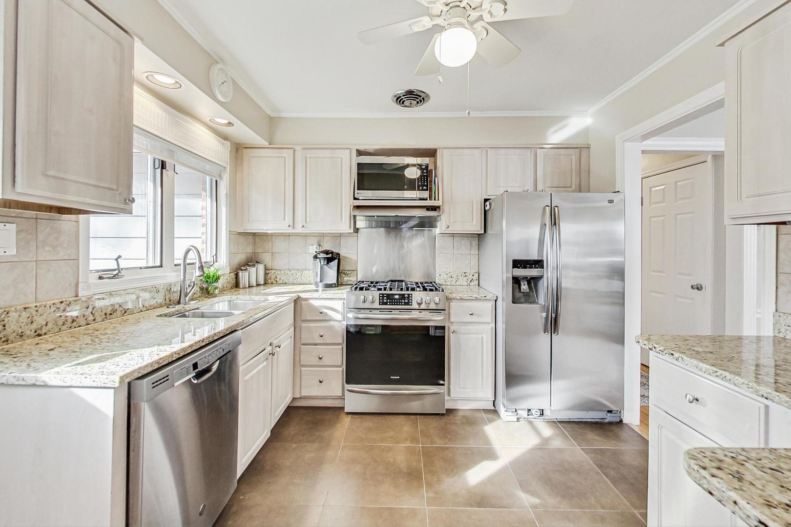 1016 Midway Road Northbrook, IL 60062 - Photo 6 of 27 a kitchen with stainless steel appliances granite countertop a stove a sink and a refrigerator