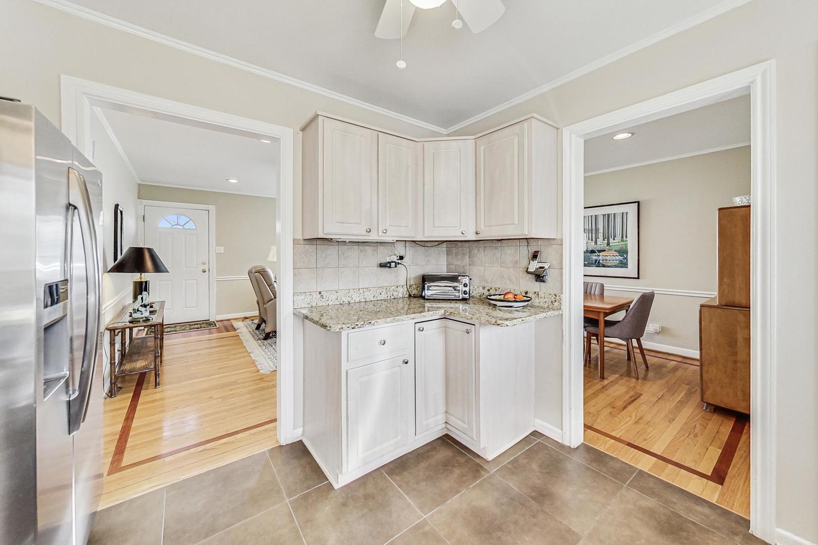 1016 Midway Road Northbrook, IL 60062 - Photo 8 of 27 a kitchen with stainless steel appliances kitchen island granite countertop a stove and white cabinets
