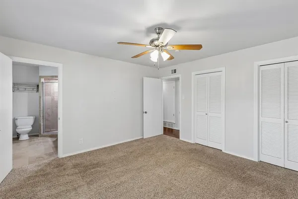 a view of an empty room and closet area