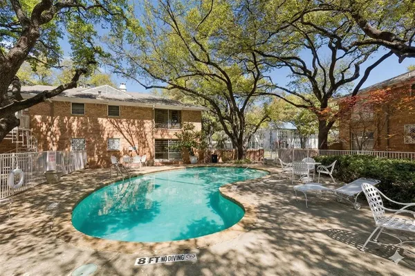 a backyard of a house with outdoor seating