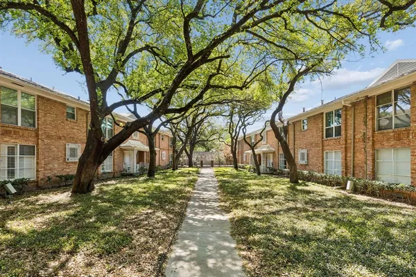 a big house with trees in front of it