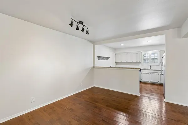 a view of a kitchen with wooden floor