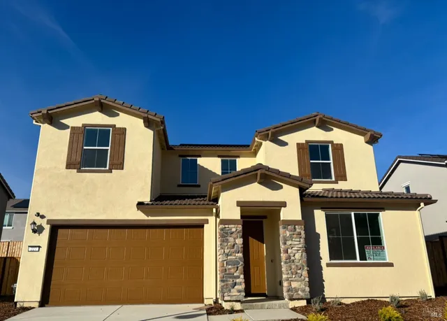 a front view of a house with a garage
