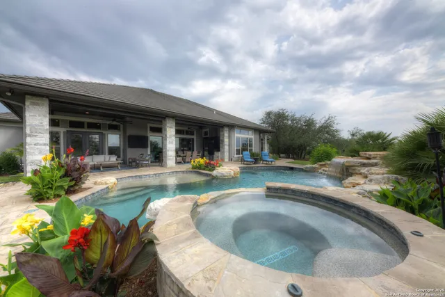 a view of house with swimming pool and outdoor seating
