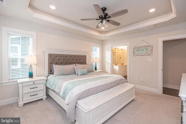 a bedroom with a bed and a lamp on dresser