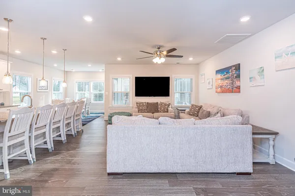 a kitchen with stainless steel appliances granite countertop a kitchen island hardwood floor sink and stove