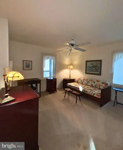 a living room with furniture and a lamp