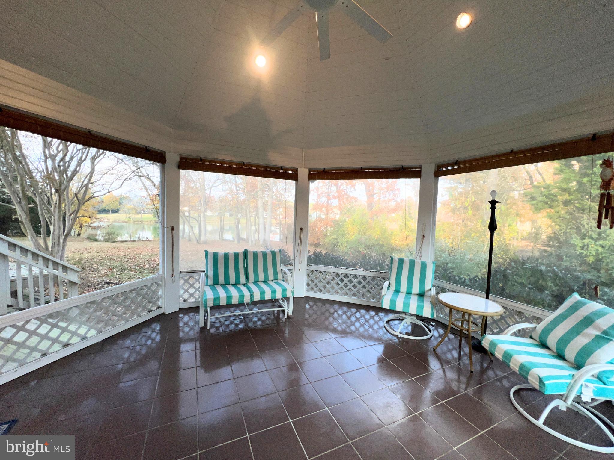 28701 Edgemere Road Easton, MD 21601 - Photo 18 of 39 a living room with furniture and a floor to ceiling window