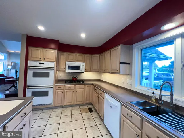 a kitchen with stainless steel appliances kitchen island granite countertop a sink and cabinets