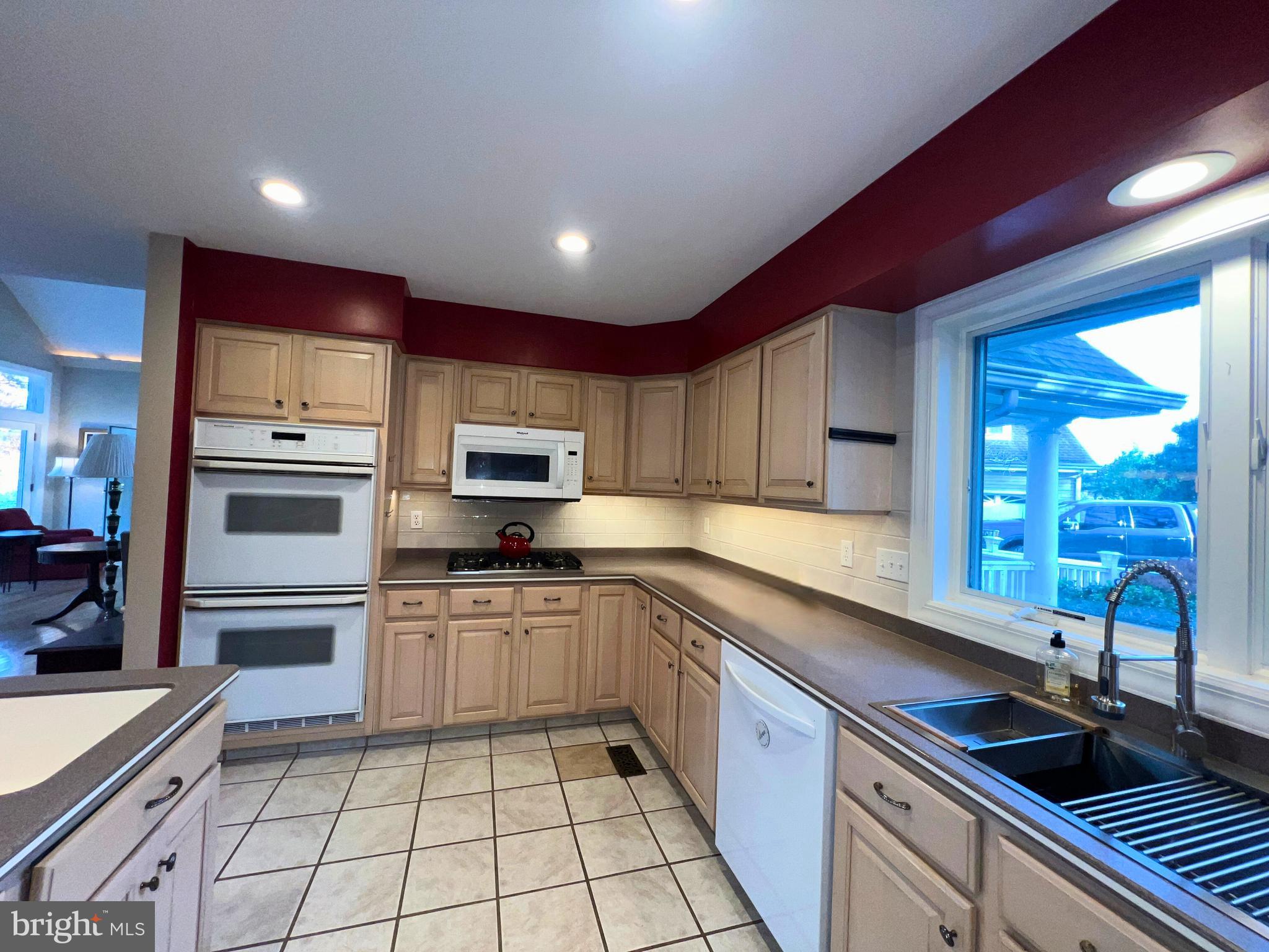 28701 Edgemere Road Easton, MD 21601 - Photo 20 of 39 a kitchen with stainless steel appliances kitchen island granite countertop a sink and cabinets