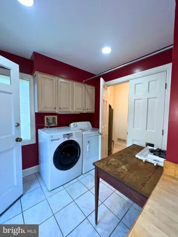 a kitchen with a stove a refrigerator and cabinets