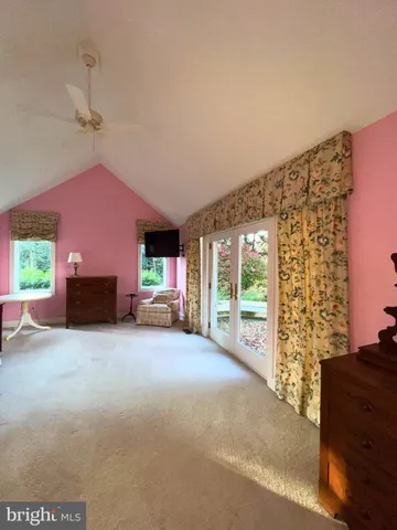 a big room with closet and a fireplace