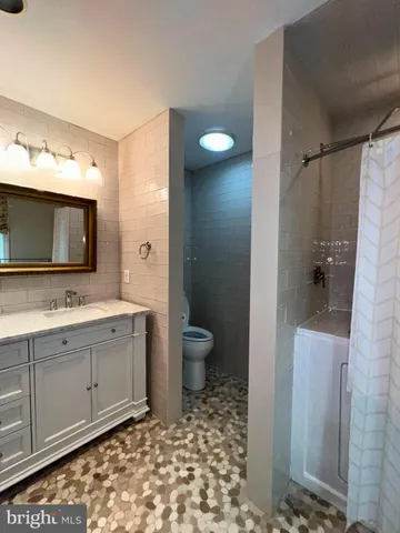 a bathroom with a toilet sink and mirror