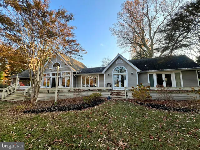 a front view of a house with yard and green space
