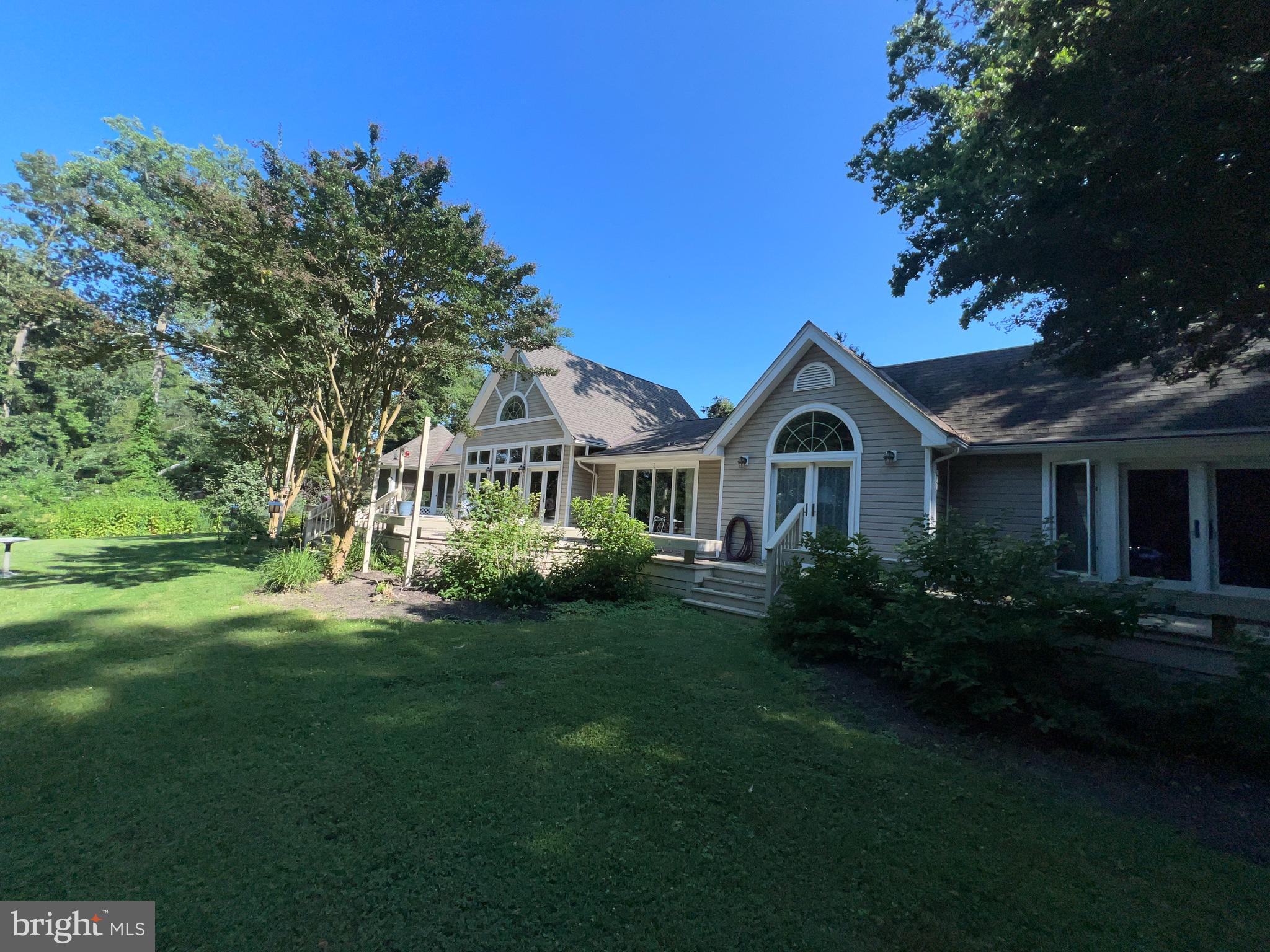 28701 Edgemere Road Easton, MD 21601 - Photo 5 of 39 a view of a house with garden and trees
