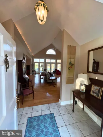a living room with furniture a dining table and a chandelier