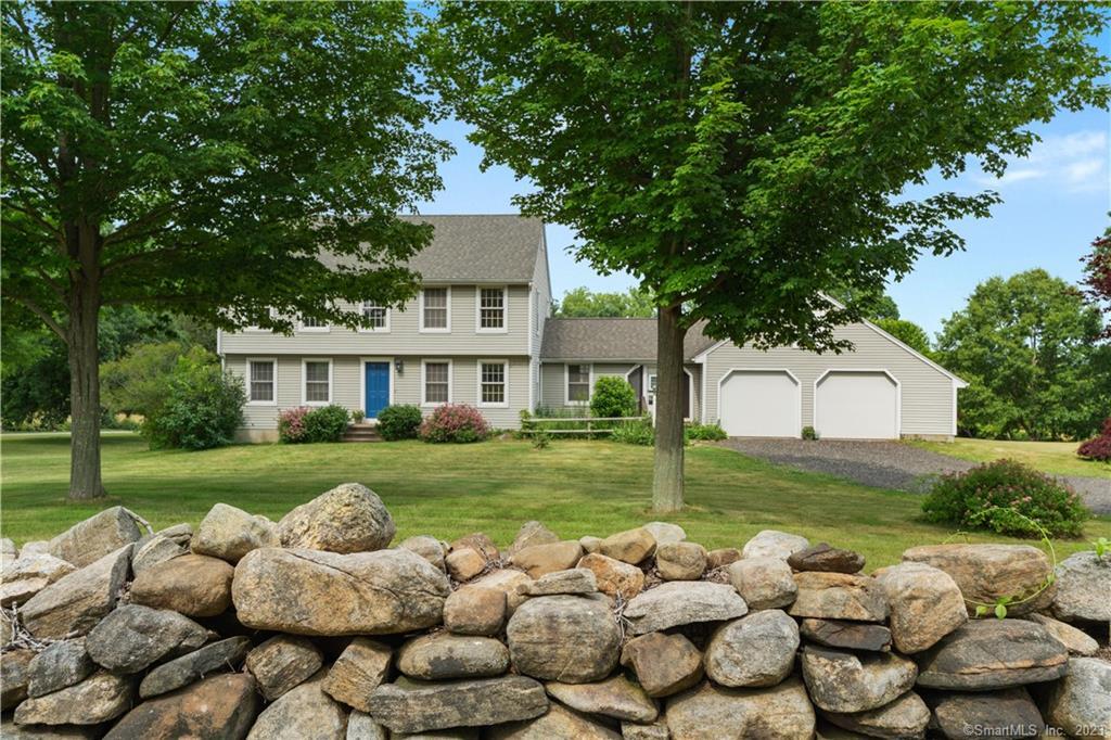 169 Tanner Marsh Road Guilford, CT 06437 - Photo 1 of 1 a front view of a house with a yard and a garden