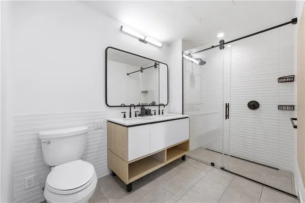 a bathroom with a toilet a sink and shower