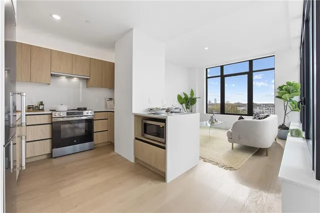 a kitchen with stainless steel appliances a stove a sink and a refrigerator