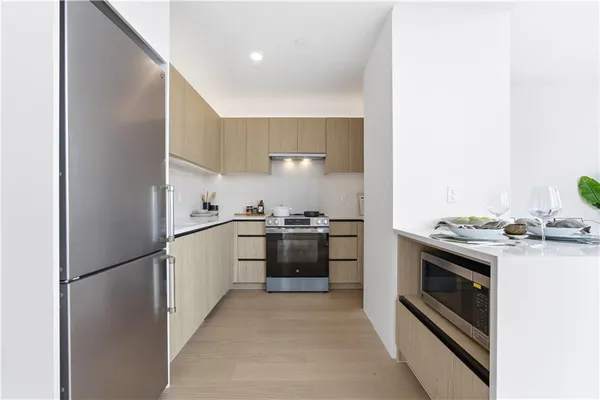 a kitchen with a stove top oven and refrigerator