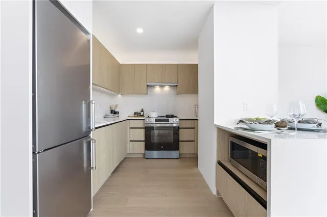 a kitchen with a stove top oven and refrigerator