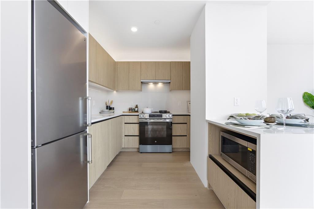 1807 66th Street, Unit 7B Brooklyn, NY 11204 - Photo 6 of 21 a kitchen with a stove top oven and refrigerator