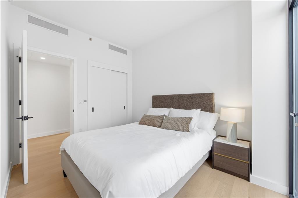 1807 66th Street, Unit 7B Brooklyn, NY 11204 - Photo 9 of 21 a bedroom with a bed and a night stand