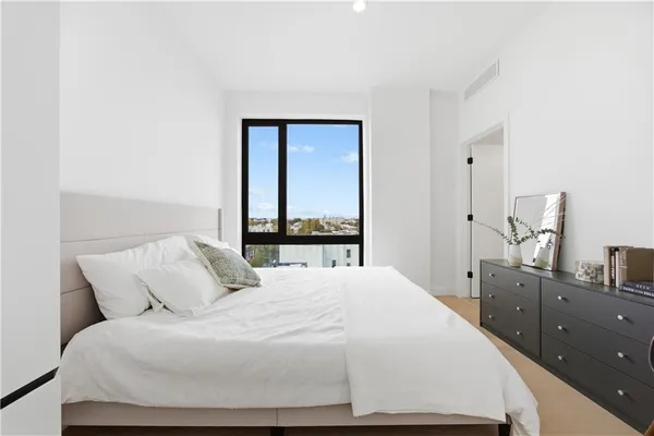 a bedroom with a large bed and a window