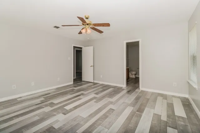 a view of room with window and ceiling fan