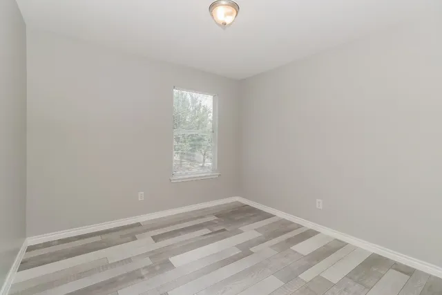 a bathroom with a sink a toilet a large mirror and vanity