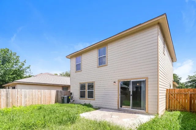 a bathroom with a toilet a sink a mirror and a window